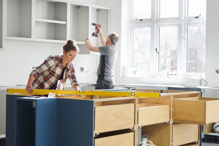The people are installing the kitchen